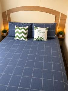 a blue bed with two pillows on it at Beachside 3 Bed Caravan with Deck & Outside Seating Mablethorpe in Mablethorpe