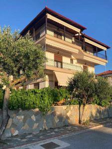 a large building with trees in front of it at Villa Eleon 2 in Nea Vrasna