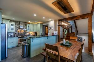 a kitchen with a wooden table and a dining room at Rockcliff Retreat in Lenoir