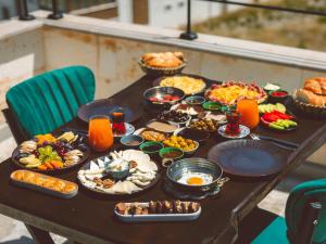 a table with a bunch of food on it at Noble Crown Stone House Cappadocia in Uçhisar