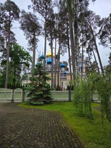 a house behind a fence with a tree in the yard at Baltic Beach Villa I in Jūrmala +27 photos