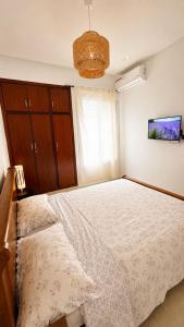 a bedroom with a large bed and a chandelier at Modern Apartment - Center of Fez in Fez