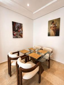 a dining room with a table and a painting at Modern Apartment - Center of Fez in Fez