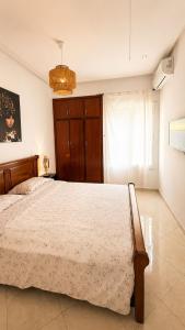 a bedroom with a bed and a chandelier at Modern Apartment - Center of Fez in Fez +8 photos