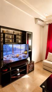 a living room with a large flat screen tv at Modern Apartment - Center of Fez in Fez