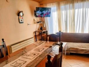 a living room with a table and a window at Alojamiento FARAH in Caviahue