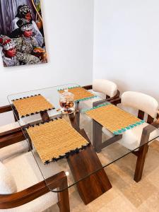 a dining room table with two chairs and a glass table at Modern Apartment - Center of Fez in Fez
