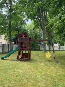 a playground with a house and a slide at Baltic Beach Villa I in Jūrmala