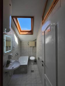 a bathroom with a sink and a toilet and a window at Apartmani MM Trebinje in Trebinje +20 photos