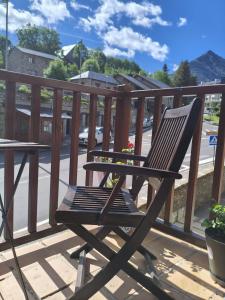 a wooden chair sitting on top of a deck at Mirador de Cerler in Cerler