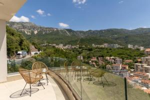 a balcony with chairs and a view of a city at Boreti Panorama Residence in Boreti