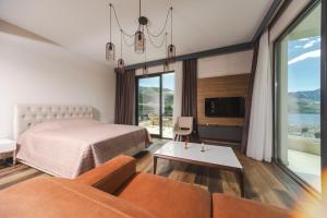 a bedroom with a bed and a couch at Boreti Panorama Residence in Boreti