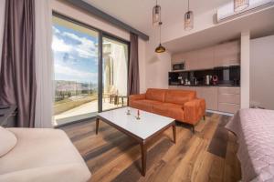 a living room with a couch and a table at Boreti Panorama Residence in Boreti