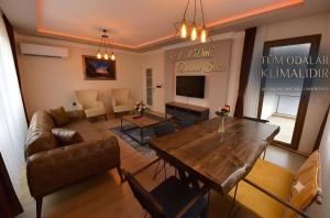 a living room with a table and a couch at İnanlar Airport Residence Trabzon in Trabzon +7 photos