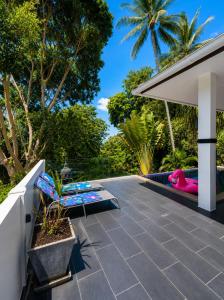 a patio with lounge chairs and a pink flamingo at Villa Ravenala in Chaweng in Ban Ko Khwan