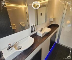 a bathroom with two sinks and a mirror at Edinburgh Festival Glamping By Stay Social Stays in Edinburgh
