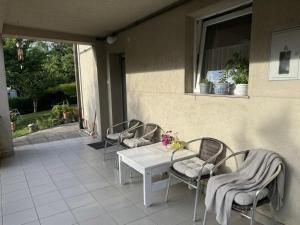 a white table and chairs on a patio at Hava 2 in Sarajevo