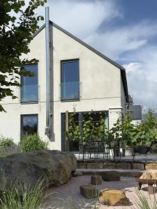 a house with glass windows and a patio at Domek u ráje in Bystřice