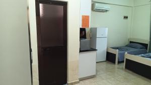 a door to a room with a kitchen and a bed at ℰ`ℋ Hotel - Velipoje rruga nr 7 in Velipojë