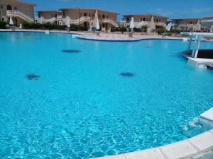 a large swimming pool with blue water at Dina Mansour's vacation home 54 A upper in Dawwār ‘Abd Allāh