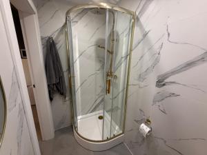 a shower with a glass door in a bathroom at Osada ŁYSKA in Żywiec +16 photos