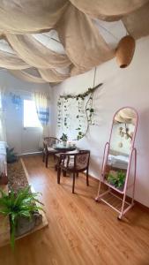 a room with a table and a mirror at T - Bona Homestay in Xã Thang Tam