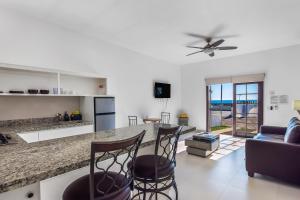 a kitchen and living room with a counter and stools at Dog-Friendly Beach Haven with Heated Pool, Hot Tub, Kitchenette, Patio, AC in Rosarito