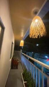a balcony with a chandelier and a railing at T - Bona Homestay in Xã Thang Tam
