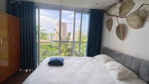 a bed in a room with a large window at T - Bona Homestay in Xã Thang Tam +65 photos