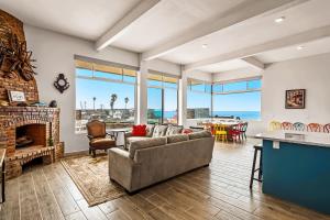 a living room with a couch and a fireplace at Tropical Retreat with Ocean Views - Steps from the sand with alfresco dining in Rosarito