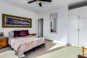 a bedroom with a bed and a ceiling fan at Dog-Friendly Oceanfront Villa with Rooftop Patio, Pool Access, & Kitchen in Rosarito +35 photos
