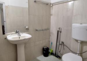 a bathroom with a sink and a toilet and a shower at Crossroad in Shillong