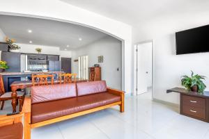 a living room with a couch and a kitchen at Dog-Friendly Ocean-View Home with Heated Outdoor Pool, Hot Tub, Streaming, Patio in Rosarito