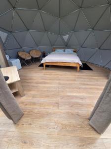 a bedroom with a bed in a pyramid tent at Spranču Glempings in Bernāti
