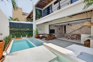 a swimming pool in the backyard of a house at La Barra Resorts Luxury Villas in Paso Hondo
