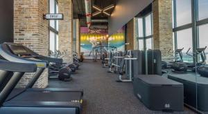 a gym with rows of treadmills and machines at Miami Downtown Bayside Balcony Studio in Miami