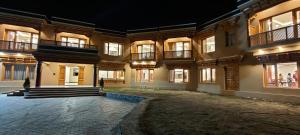 an empty courtyard of a building at night at The Pamir Hotel in Nubra