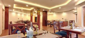 a restaurant with tables and chairs in a room at The Pamir Hotel in Nubra