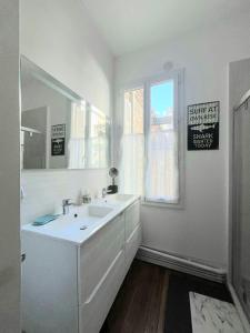 a white bathroom with a sink and a window at La Villa Turquoise in Le Tréport +29 photos
