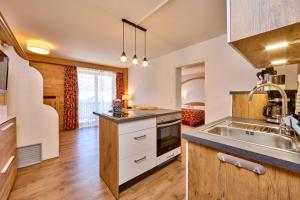 a kitchen with a sink and a counter top at Alpenhof Wallgau in Wallgau