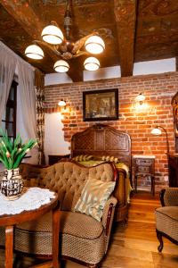 a living room with two couches and a brick wall at Apartamenty Molus na Rynku Staromiejskim in Toruń
