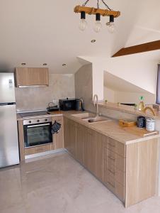 a kitchen with a sink and a refrigerator at Luxury suite with Olympus and sea view in Litochoro +35 photos