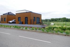 a building on the side of a road at Les Coquelicots - Parking privé, Terrasse, Clim, Netflix, Au Calme in Hem-Lenglet