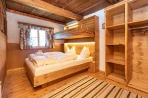 a bedroom in a log cabin with a bed and shelves at Appartement Alpenfex in Flachau