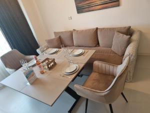 a living room with a table and a couch at Apartament BEACH VIBES Nessebar in Nesebar