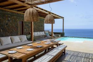 a living room with a table and a pool at São Pedro Bay in Mindelo