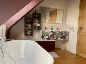a bathroom with a bath tub and a staircase at Ti Toenn et spa in Landéda