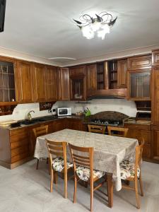 a kitchen with wooden cabinets and a table and chairs at Antica Casa Cavaliere in Tramonti