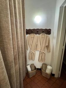 a bathroom with two shirts and baskets and curtains at Le Rêve Ocre in Toulon +11 photos