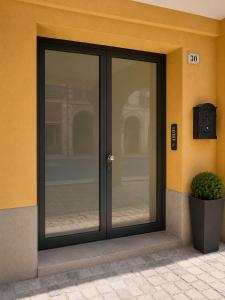 an entrance to a building with glass doors at LOFT EMILIA - la tappa perfetta tra Bologna e Ravenna - SELF CHECK-IN in Castel Bolognese